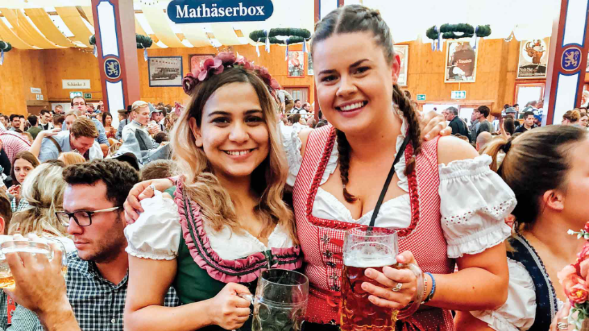 Two girls with beer steins at the Busabout Oktoberfest festival in Germany