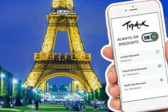 Mock up picture of Eiffel Tower in the background with the Topdeck always-on discounts pages loaded on an iPhone