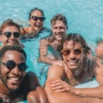 A group of Contiki passengers in a swimming pool at the Chateau De Cruix in France