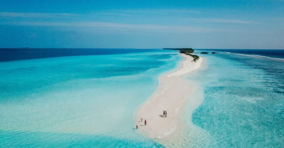 A beautiful remote island in the Maldives with two people on it