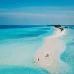 A beautiful remote island in the Maldives with two people on it