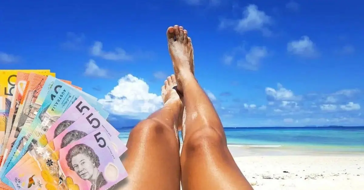 Girls legs on beach with Australian currency notes
