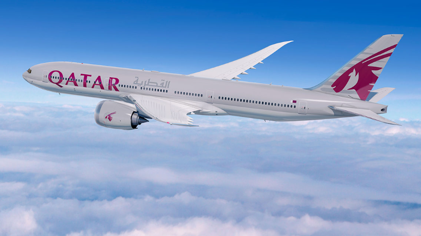 A Qatar plane flying high above clouds