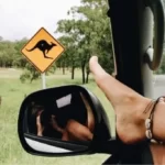 Girl with foot on car window Australian road trip