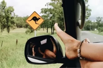 Girl with foot on car window Australian road trip